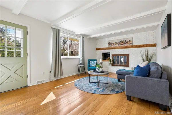 a living room with a bed furniture and a window