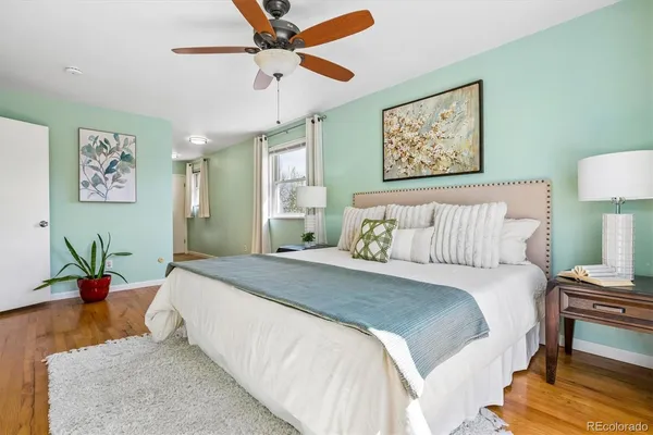 a bedroom with a bed and wooden floor
