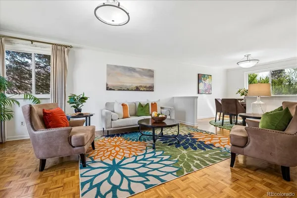 a living room with furniture wooden floor and a window