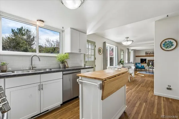 a kitchen with a stove a sink and a refrigerator