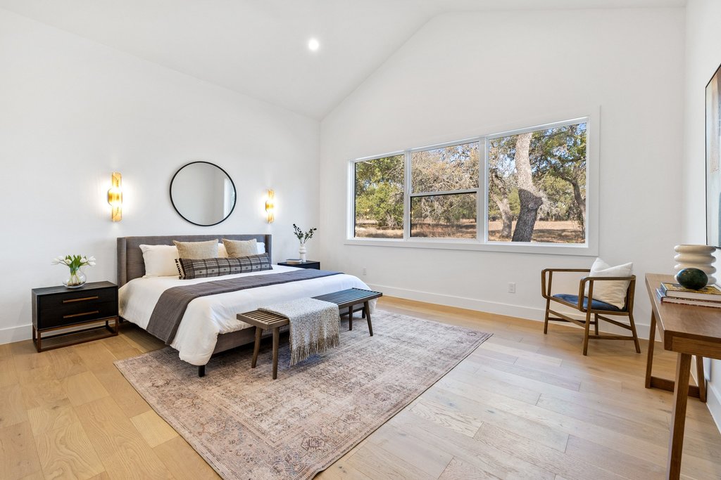 47 War Bonnet Wimberley, TX 78676 - Photo 23 of 40 Bedroom with light wood-type flooring, recessed lighting, and high vaulted ceiling