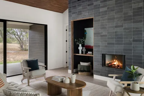 a living room with furniture a fireplace and a flat screen tv