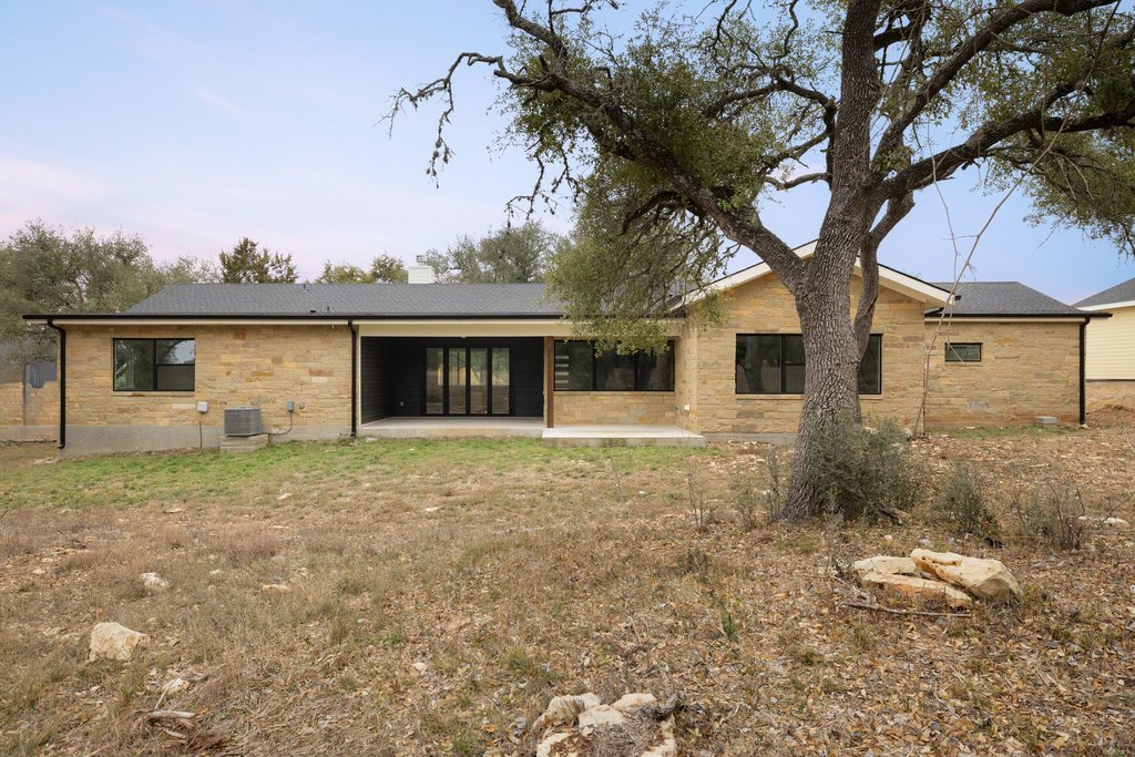 47 War Bonnet Wimberley, TX 78676 - Photo 38 of 40 Rear view of property with a patio area and a chimney