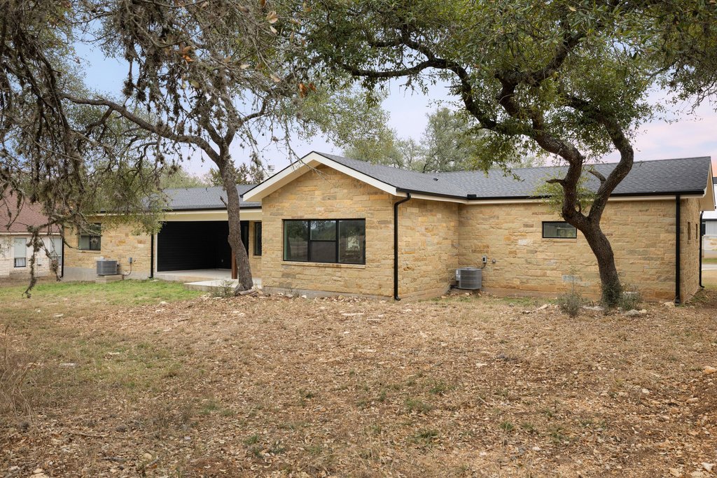 47 War Bonnet Wimberley, TX 78676 - Photo 39 of 40 Back of house featuring a patio and stone siding
