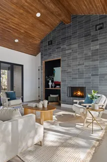 a living room with fireplace furniture and a fireplace