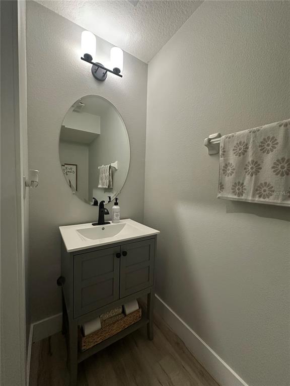 7544 Red Mill Circle New Port Richey, FL 34653 - Photo 14 of 31 a bathroom with a sink a light fixture and a mirror