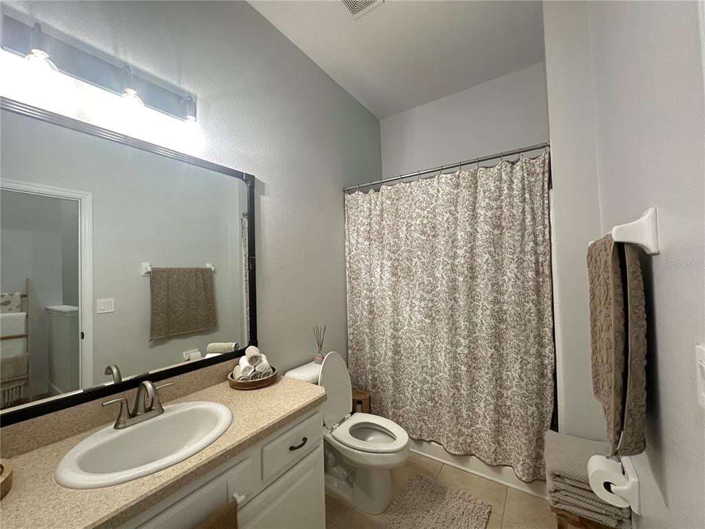 7544 Red Mill Circle New Port Richey, FL 34653 - Photo 20 of 31 a bathroom with a sink toilet and shower