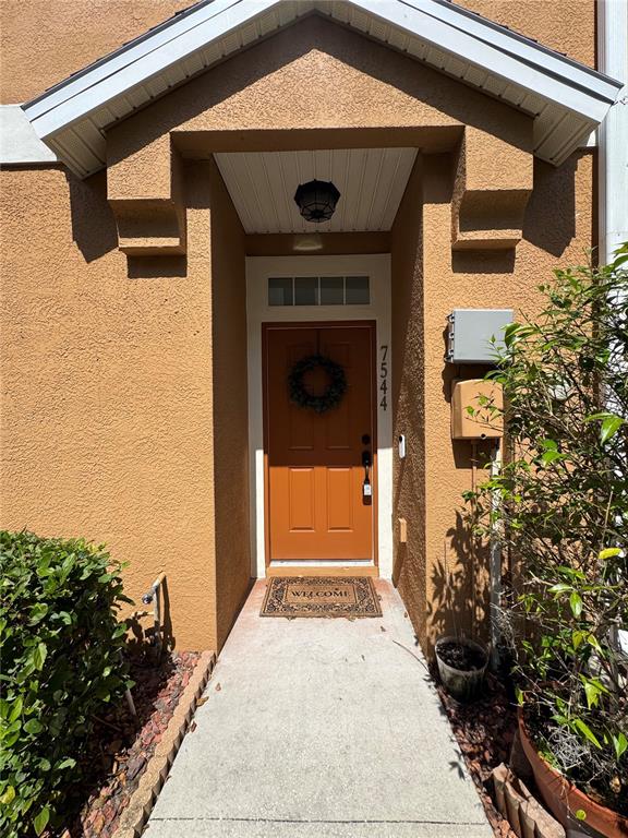 7544 Red Mill Circle New Port Richey, FL 34653 - Photo 2 of 31 a front view of a house with a yard