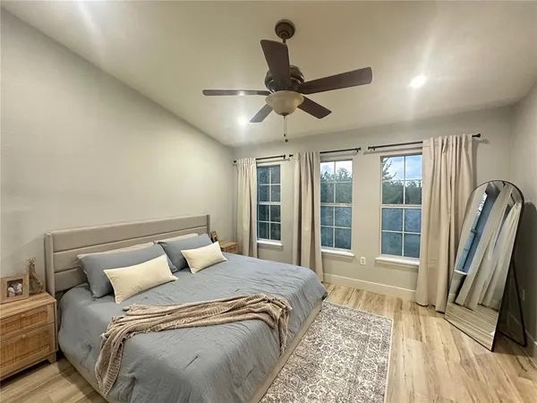 a bedroom with a large bed and a large window