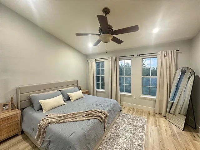 a bedroom with a large bed and a large window