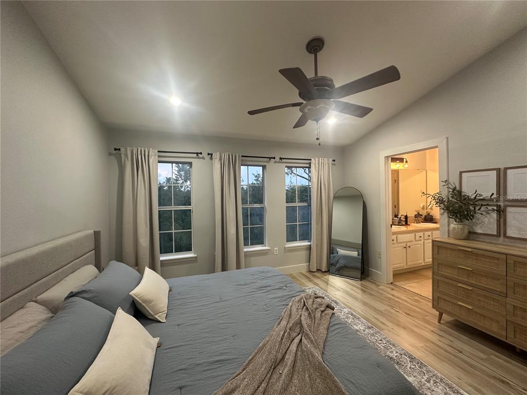 7544 Red Mill Circle New Port Richey, FL 34653 - Photo 22 of 31 a bed room with a bed and a large window