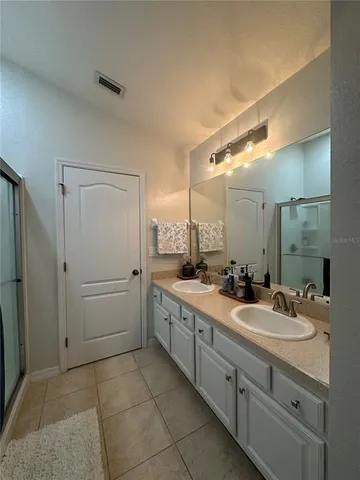 a bathroom with a double vanity sink mirror and double