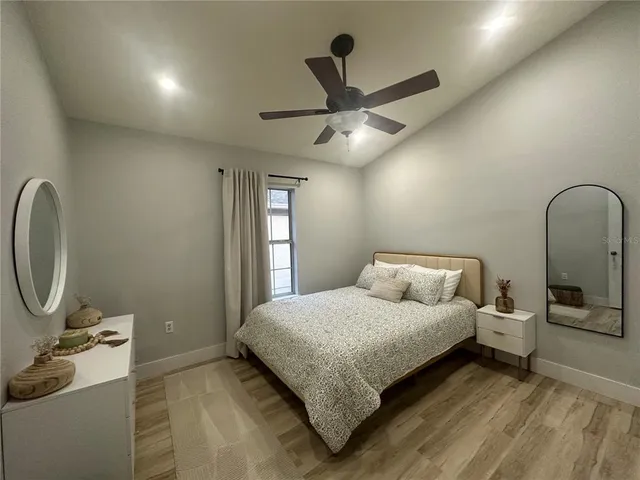 a bedroom with a bed and a chandelier