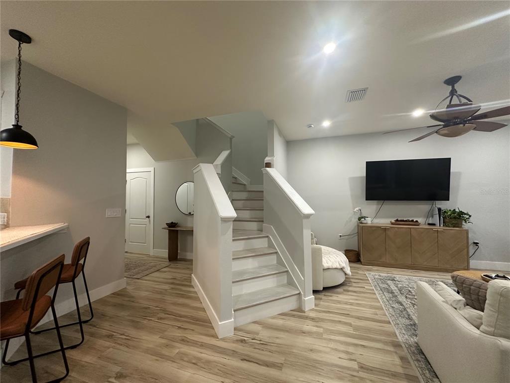 7544 Red Mill Circle New Port Richey, FL 34653 - Photo 3 of 31 a living room with furniture and a flat screen tv