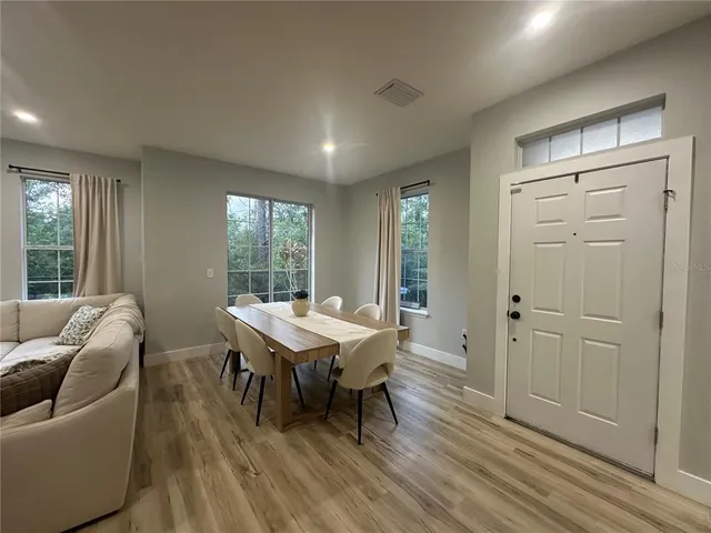 a view of a livingroom with furniture window and wooden floor