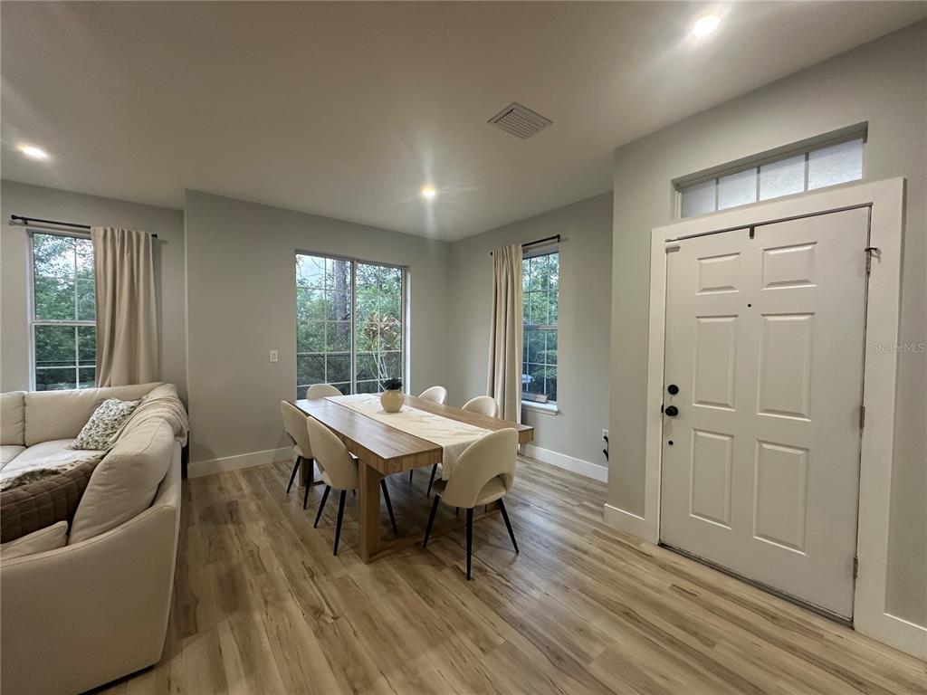 7544 Red Mill Circle New Port Richey, FL 34653 - Photo 6 of 31 a view of a livingroom with furniture window and wooden floor