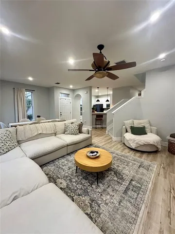 a living room with furniture and a wooden floor