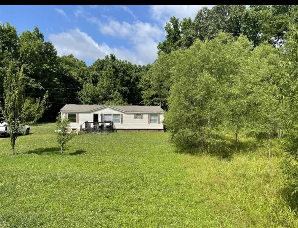 1447 Chipman Road Ripley, TN 38063 - Photo 1 of 1 a front view of a house with a yard