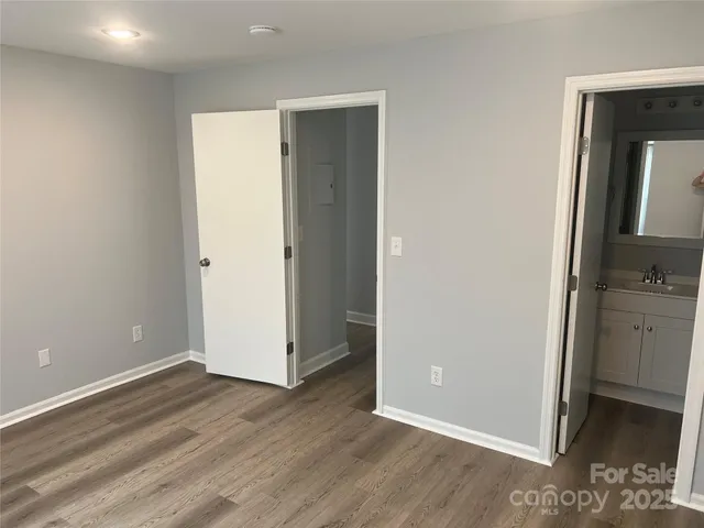 a view of a room with wooden floor