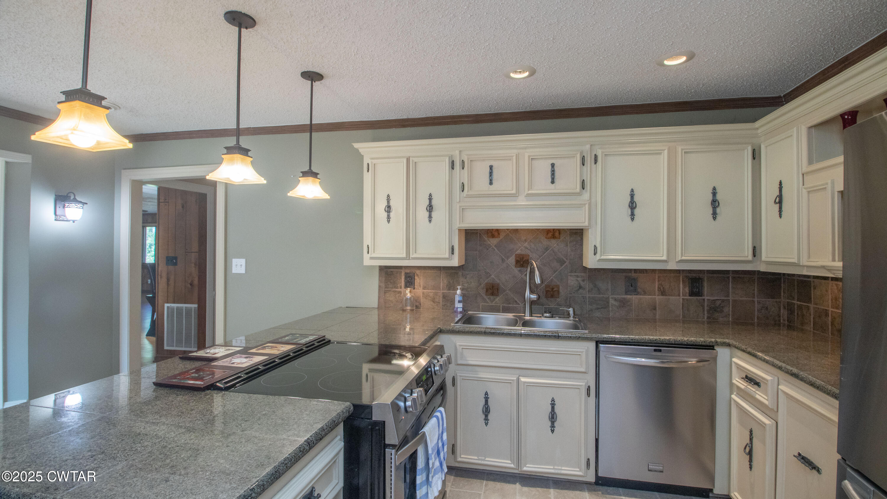 23 Forked Oak Road Humboldt, TN 38343 - Photo 18 of 90 a kitchen that has a lot of cabinets in it with granite countertop stainless steel appliances