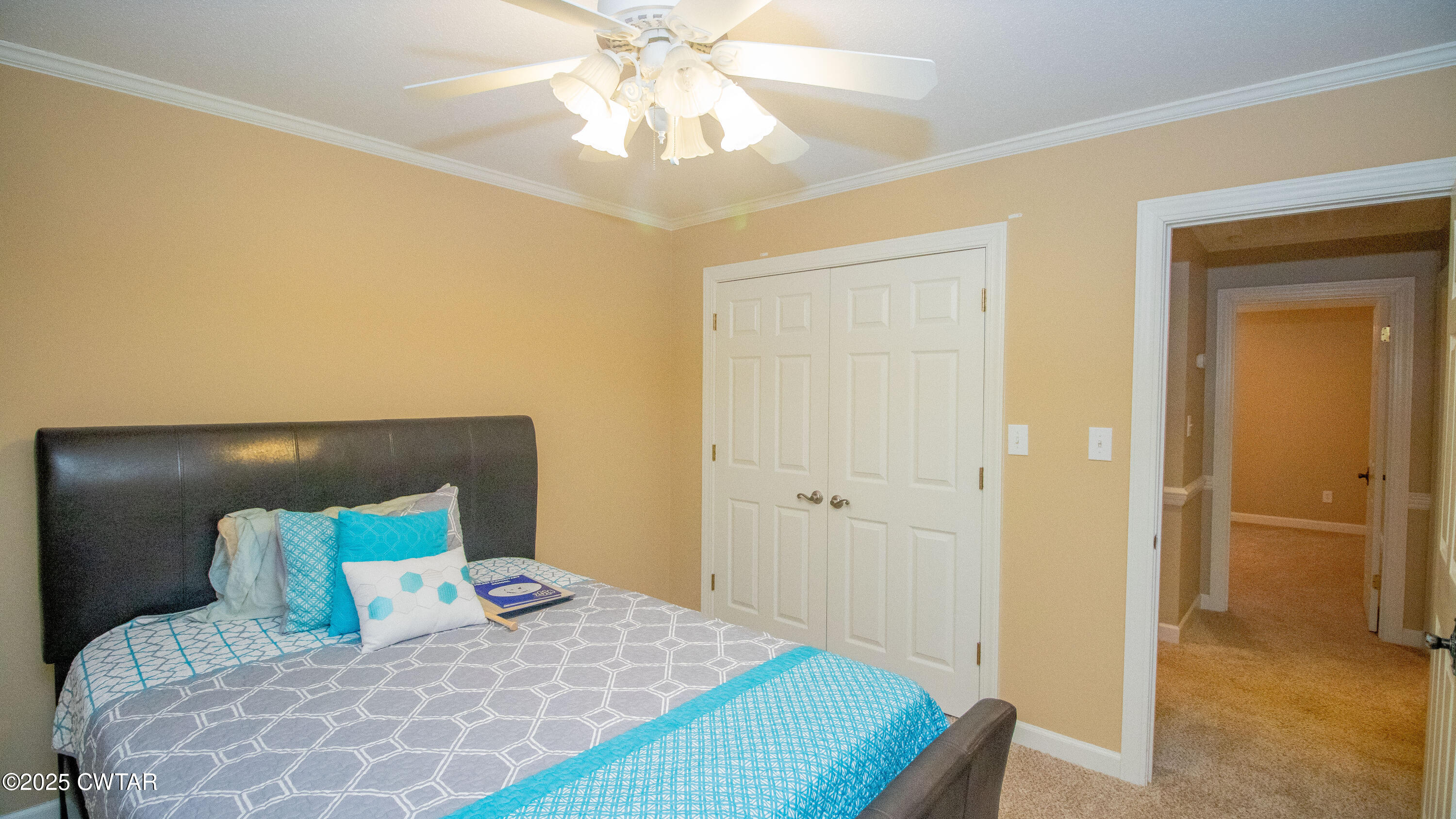 23 Forked Oak Road Humboldt, TN 38343 - Photo 66 of 90 a bedroom with a bed and a chandelier