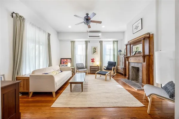 a living room with furniture a fireplace and a flat screen tv
