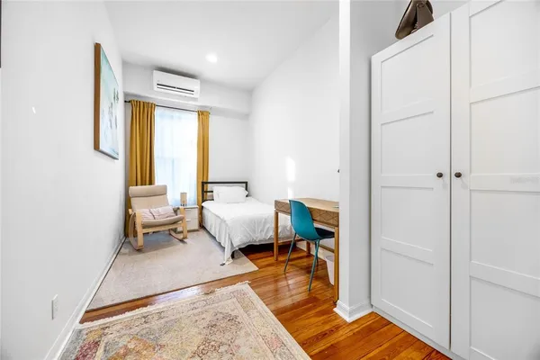 a kitchen with stainless steel appliances kitchen island granite countertop a table chairs sink refrigerator and cabinets