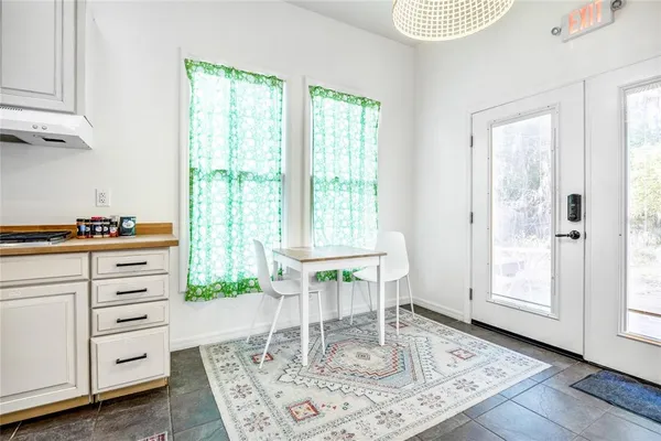 a large kitchen with kitchen island a stove a sink a refrigerator and cabinets