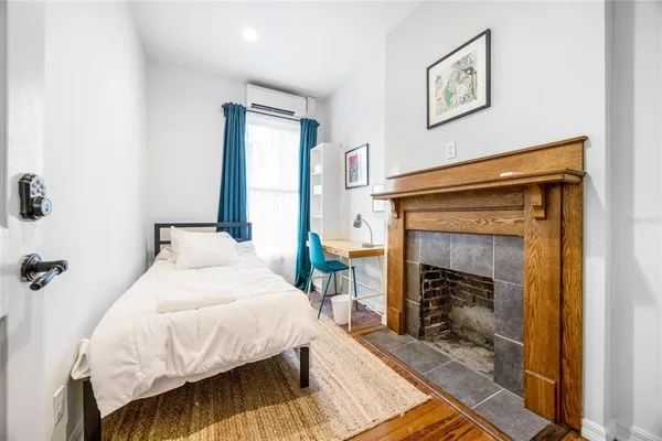 a bedroom with a bed and wooden floor