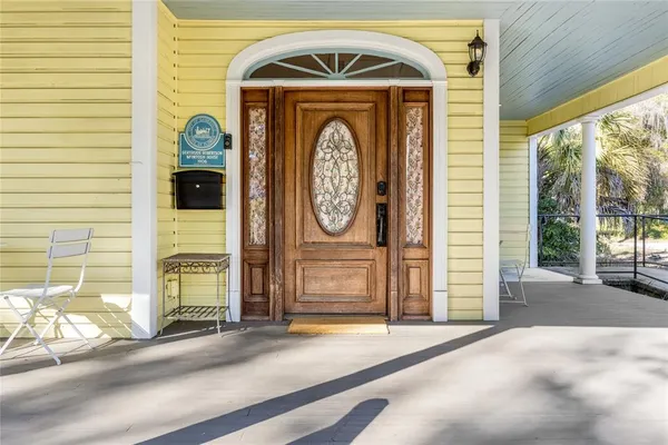 a view of a hallway with wooden floor and a window