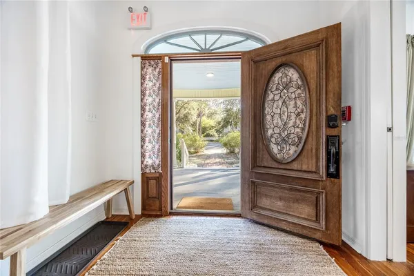 a view of a livingroom with furniture and a hallway