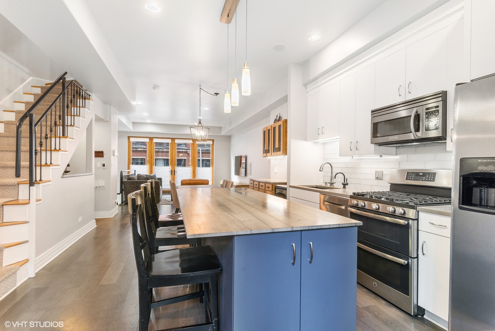 916 West Van Buren Street Chicago, IL 60607 - Photo 9 of 27 a kitchen with stainless steel appliances granite countertop a stove top oven a sink dishwasher and cabinets with wooden floor