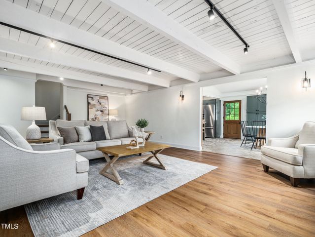 a living room with furniture fireplace and window