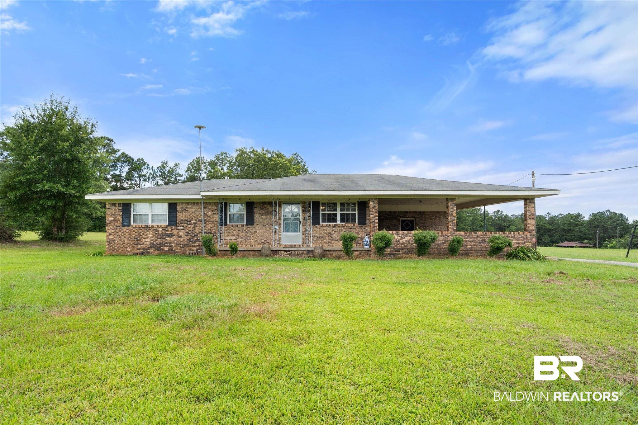 11601 Lott Road Chunchula, AL 36521 - Photo 1 of 34 Ranch-style home featuring brick siding and a front lawn