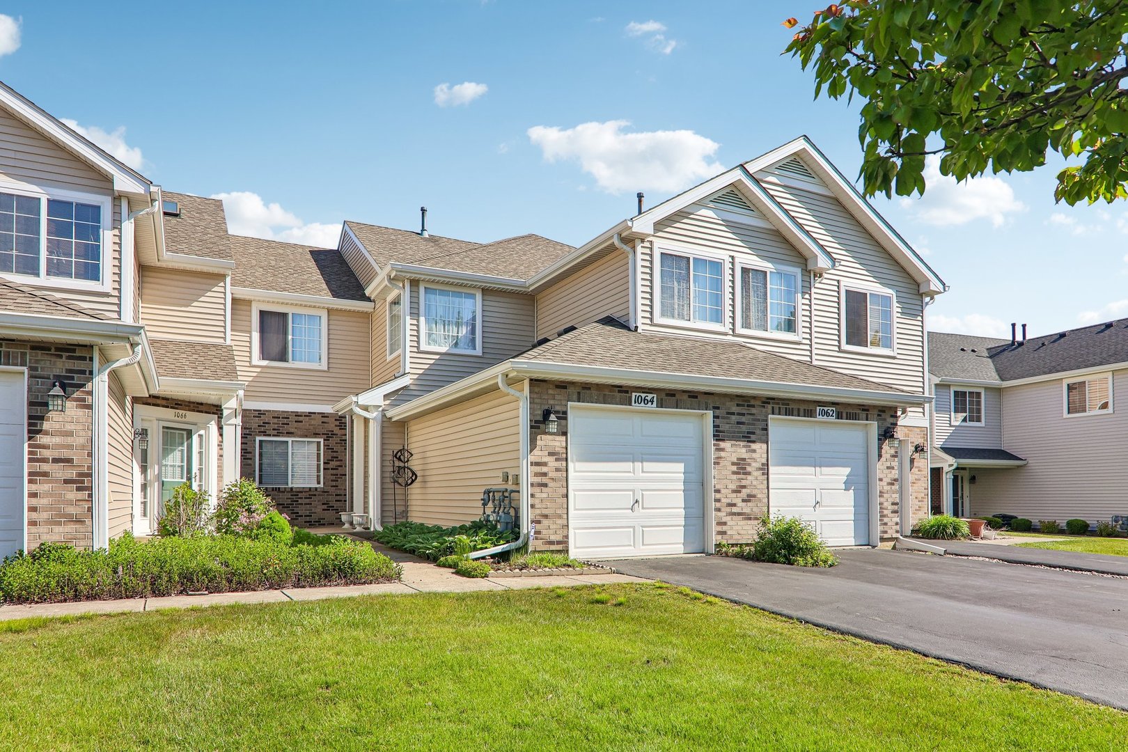 1064 Ripple Ridge Darien, IL 60561 - Photo 2 of 16 a front view of a house with a yard and garage