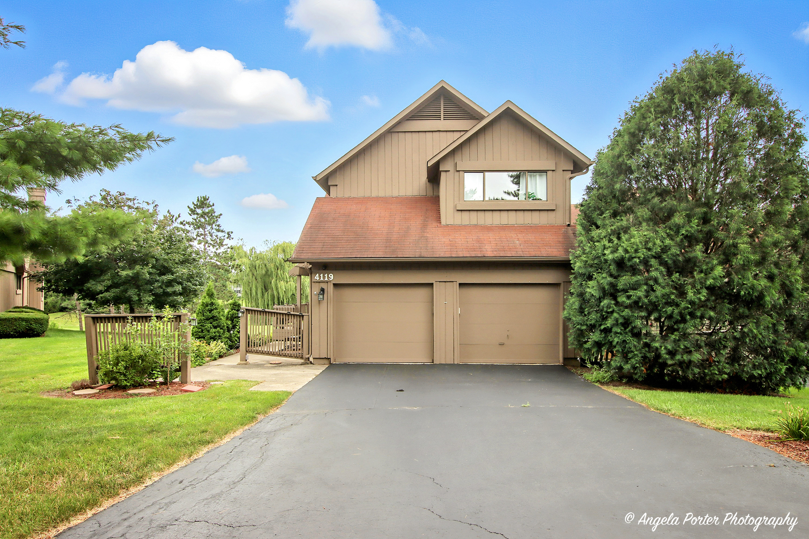 a front view of a house with a garden and yard
