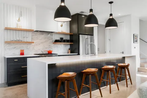 a kitchen with stainless steel appliances a stove a sink and cabinets