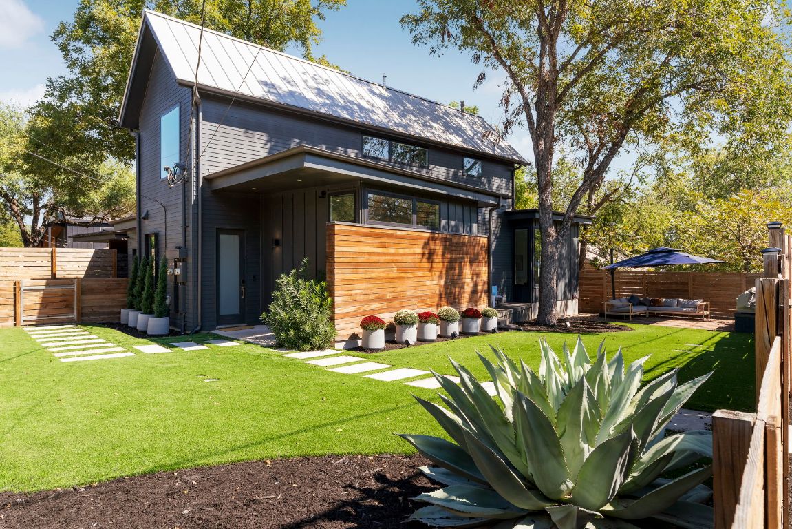 The modern facade and corner-lot setting create a polished first impression in coveted 78704.