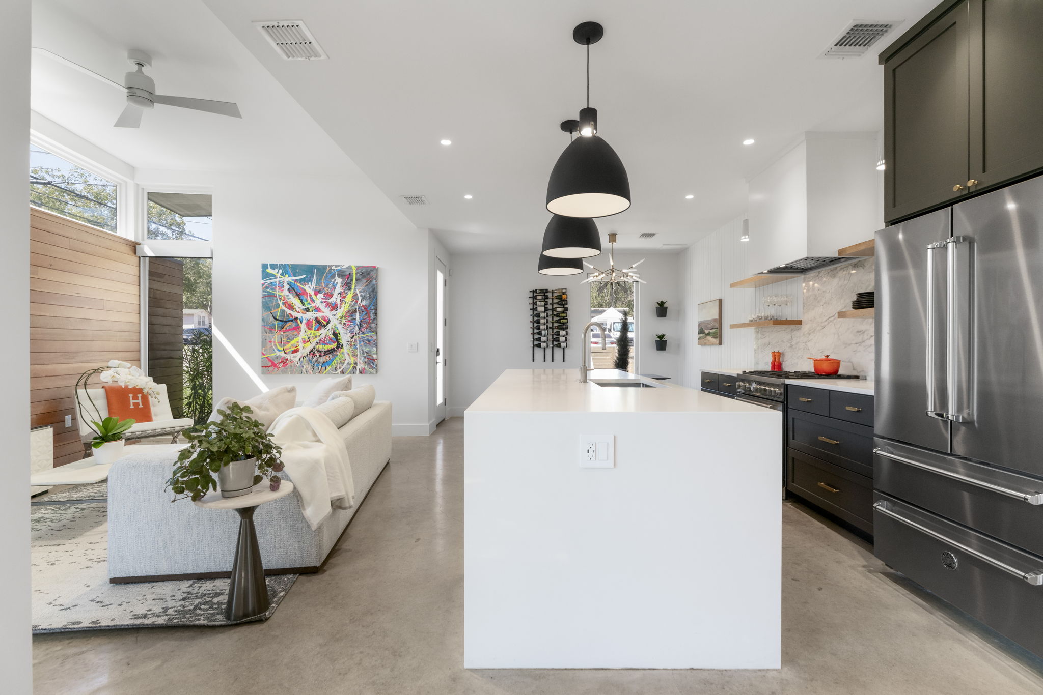 604 Cumberland Road Austin, TX 78704 - Photo 15 of 40 a kitchen with stainless steel appliances kitchen island granite countertop a refrigerator a sink a stove and a wooden floors