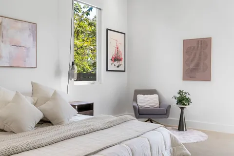 a bedroom with a bed and a lamp