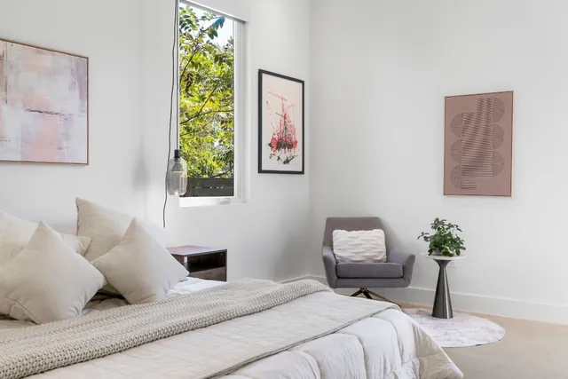 a bedroom with a bed and a lamp