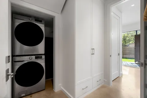 a view of a hallway with washer and dryer