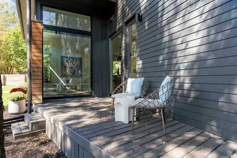 a wooden bench sitting in front of a building