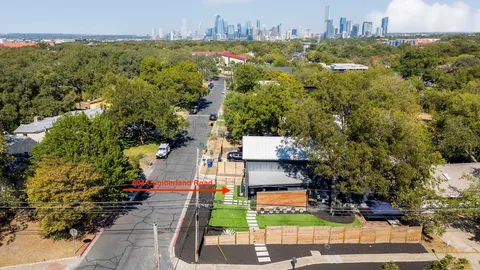 an aerial view of residential houses with yard