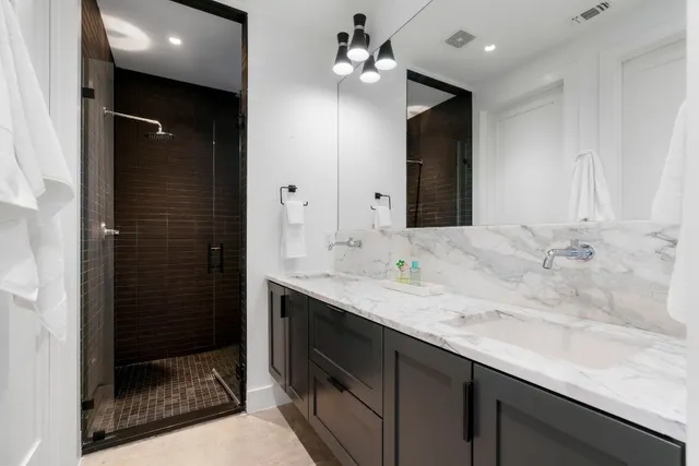 a bathroom with a sink a vanity and shower