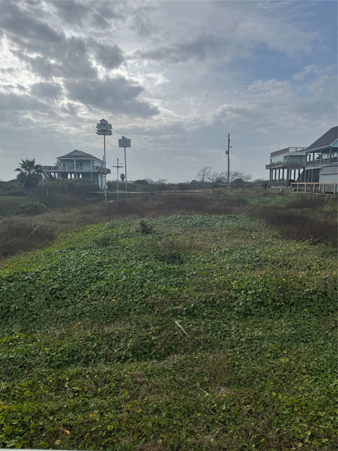 0 South Tinkle Lane Crystal Beach, TX 77650 - Photo 2 of 5 a view of a water pond with lots of green space
