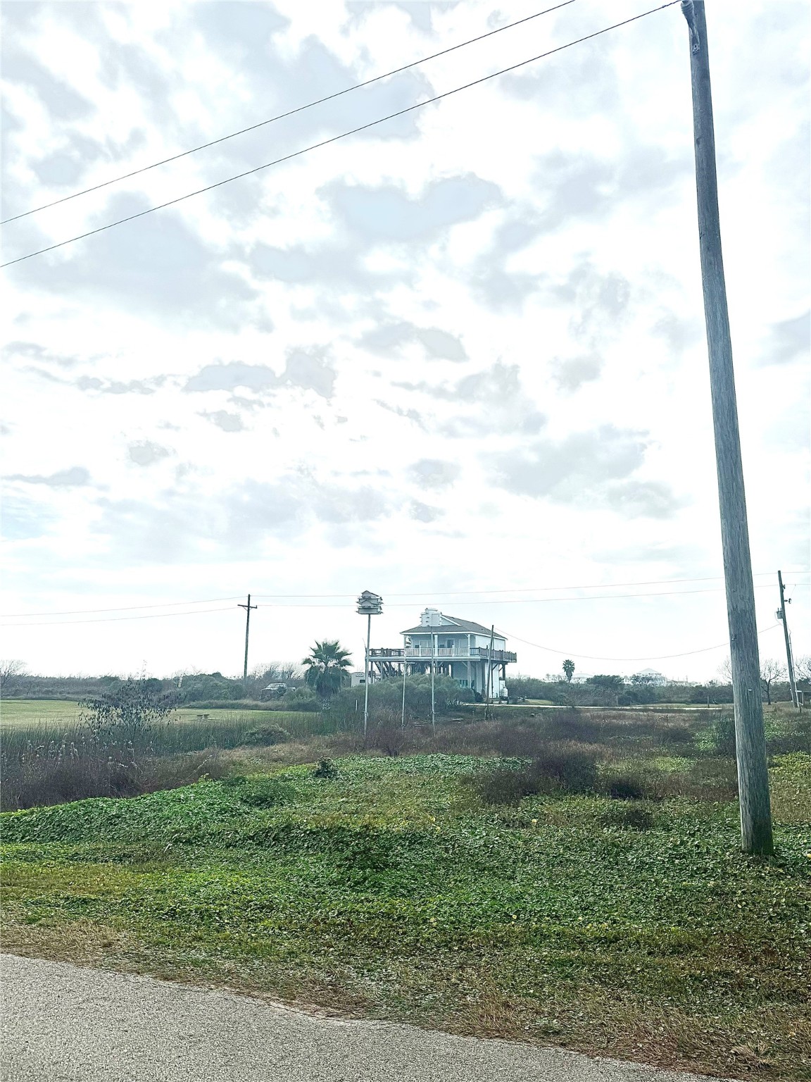 0 South Tinkle Lane Crystal Beach, TX 77650 - Photo 4 of 5 a view of a field with an trees
