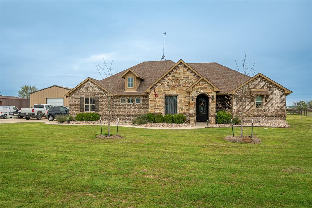 a front view of a house with a yard and garage