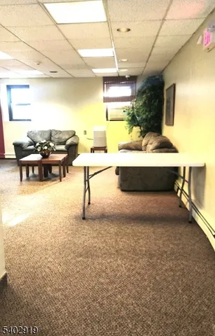 a living room with couch and a large window