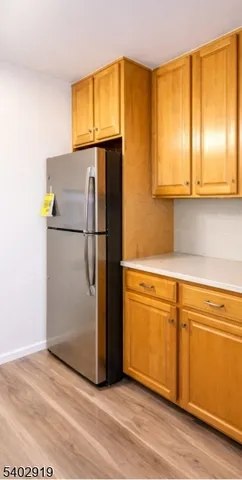 a kitchen with a refrigerator and a sink